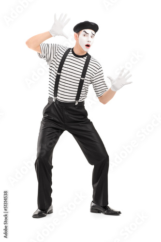 Full length portrait of a male mime artist performing