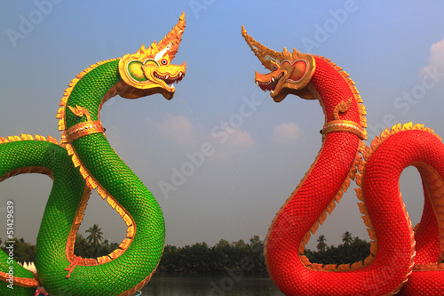 Silhouettes dragon and Naga statue protecting Thai temple