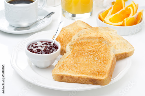 breakfast with toasts, jam, coffee and orange juice