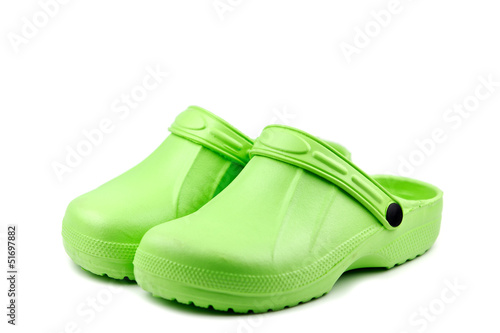 Bright green clogs isolated on white background