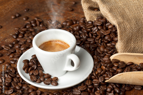 coffee cup with burlap sack of roasted beans