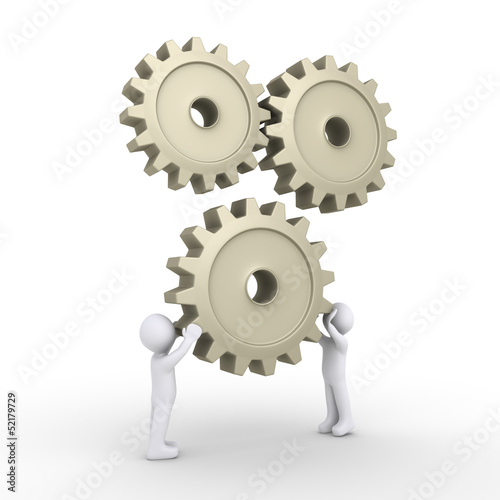 Two persons attach cogwheel