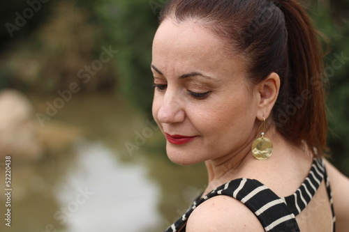 Beautiful brunette woman posing at the park