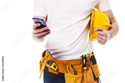 Close-up of construction worker using a mobile phone