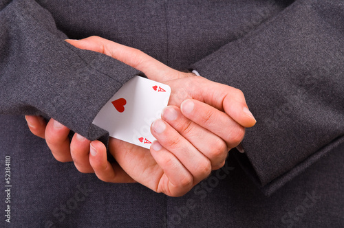 Businessman with ace card hidden under sleeve.