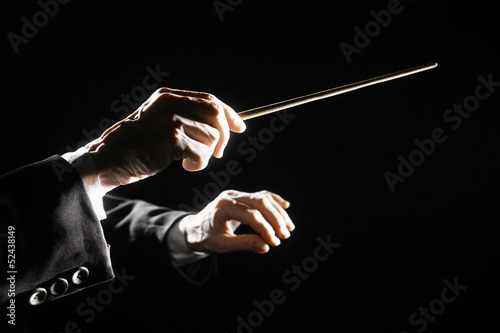 Orchestra conductor hands baton