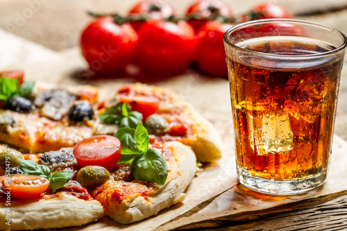 Freshly baked pizza and served with cold drink