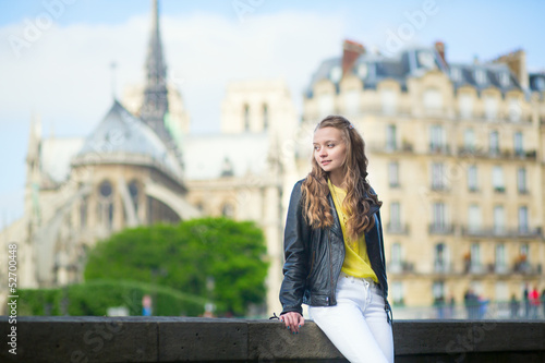 Young beautiful Parisian girl near Notre-Dame