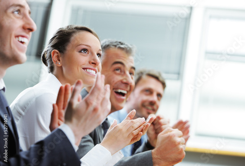 Clapping business people