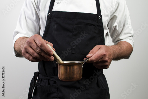 chef holding copper pan