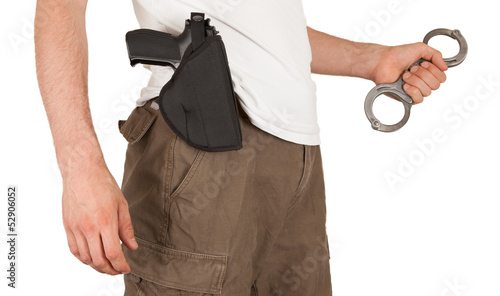 Close-up of a man with a gun and handcuffs