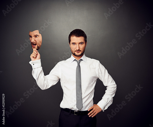 man holding mask with bad mood