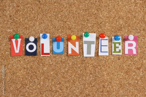 The word Volunteer on a cork notice board