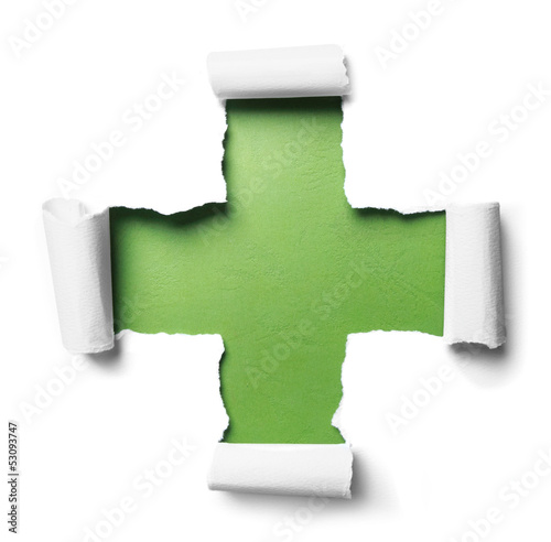 white torn paper with plus shape over green