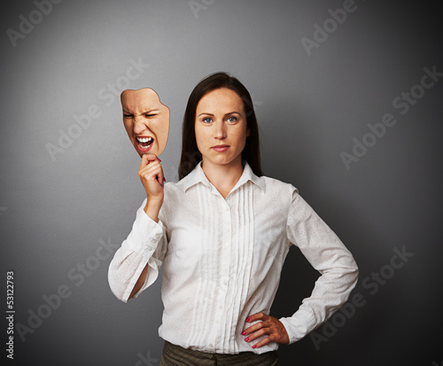 quiet woman holding aggressive mask