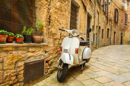 Old Vespa scooter on the street in Italy