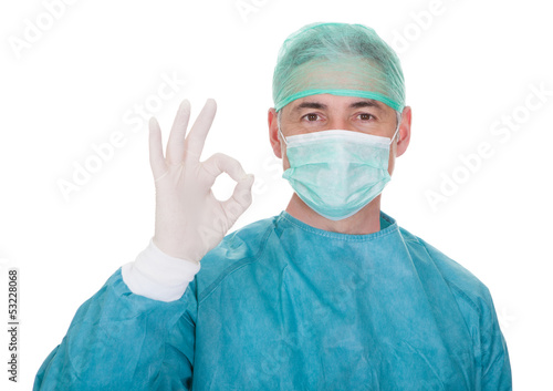 Mature Male Surgeon Gesturing Ok Sign