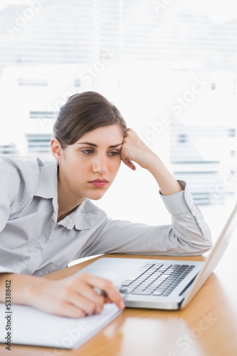 Fed up businesswoman at her desk