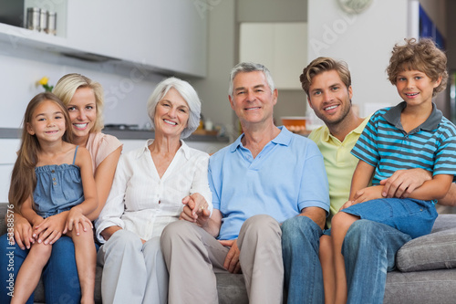 Extended family sitting on couch in living room