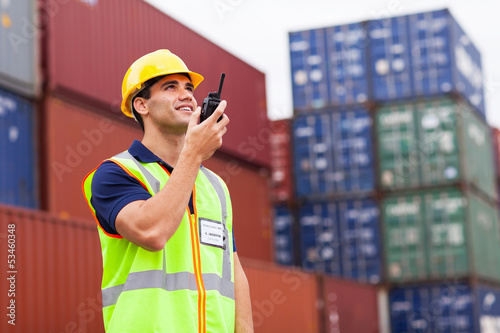 harbor worker talking on the walkie-talkie