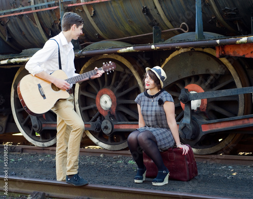 Retro young love couple vintage serenade train setting