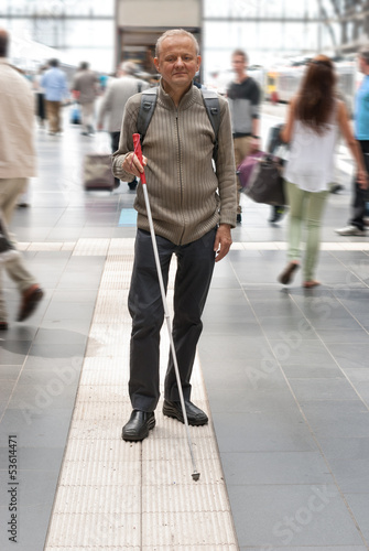 Blind man uses the tactile guidance system in the station