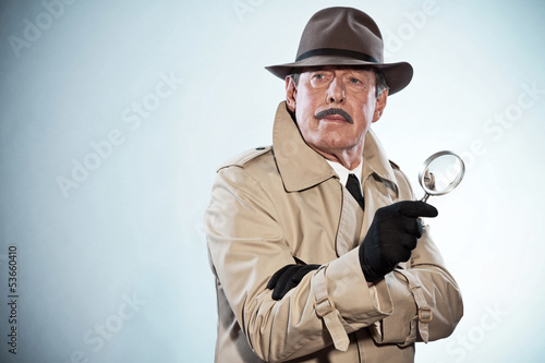 Retro detective man with mustache and hat. Holding magnifying gl