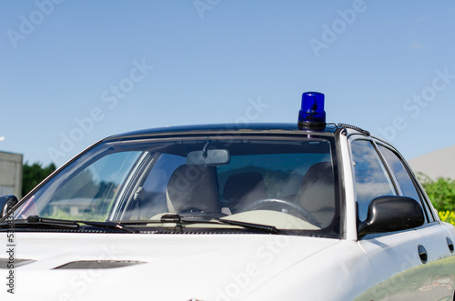 White duty car with blue flasher on top