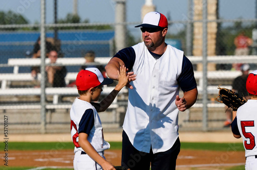 Little league baseball boy with coach