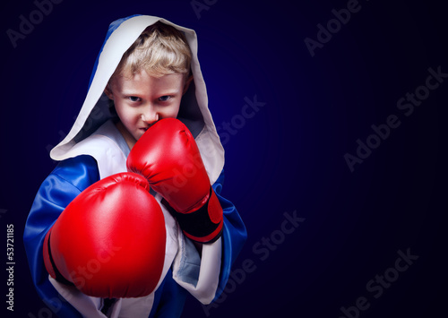 Boxing fighter boy portait on blue background