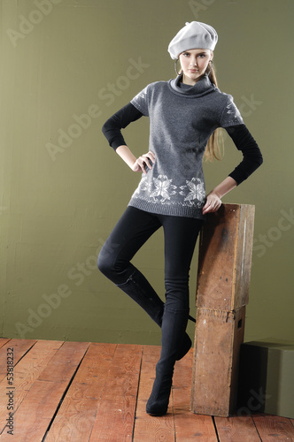pretty young woman near cube posing wooden floor
