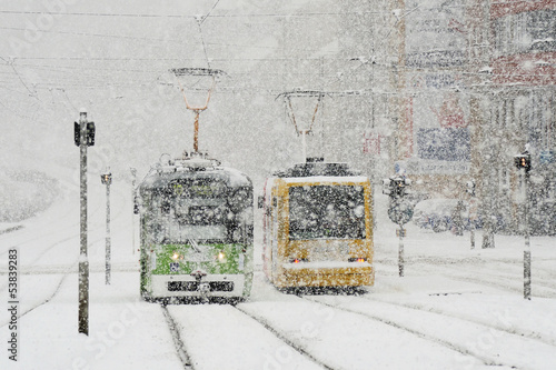 Winter city with trams and snow