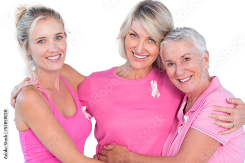 Women wearing pink tops and ribbons for breast cancer