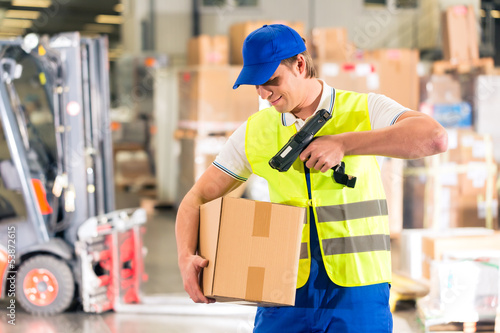 Lagerist von Spedition scannt Paket in einem Lager