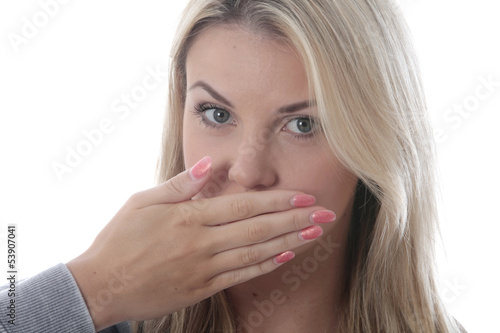 Model Released. Young Woman Covering Her Mouth