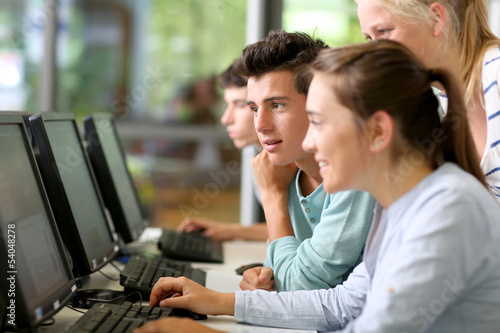 Students in class working on desktop computer