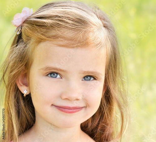 Outdoor portrait of adorable smiling little girl