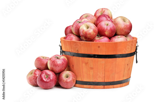 Studio shot of red apples in a wooden bucket