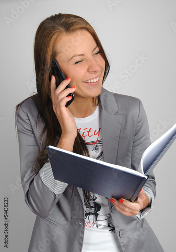 Woman talking by cell phone and smiling.