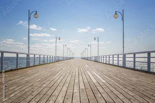 Old empty wooden pier over the sea shore with copy space