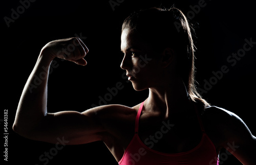 woman athlete showing biceps