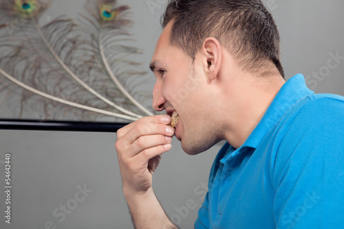 Man eating a mouthful of bread