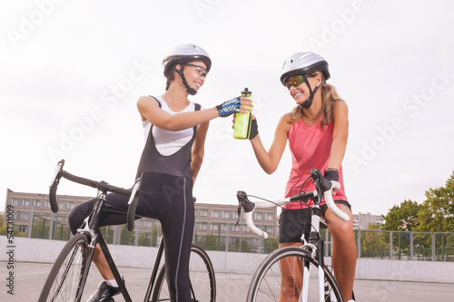 Cyclist woman takes a water break