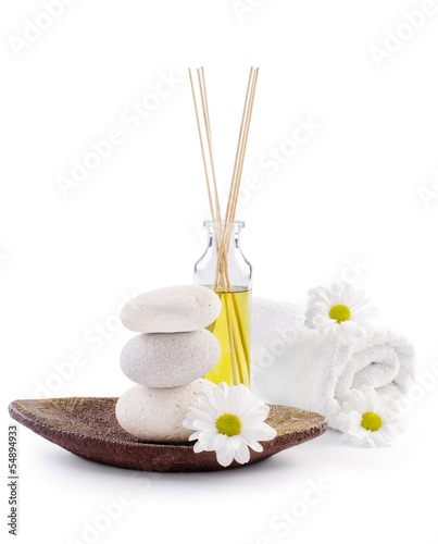 spa decoration with stones, daisies and masssage oil