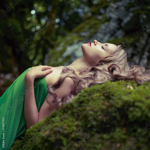 Beautiful lady in the coniferous forest