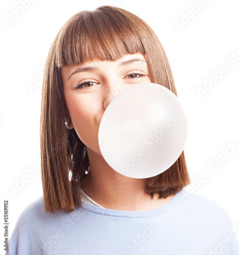 girl doing a bubble with a chewing gum on a white background