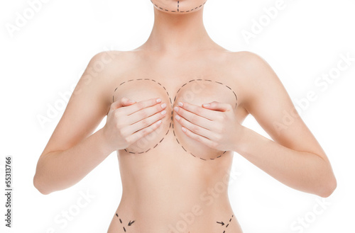 Body improving. Cropped image of female body with marks on breas