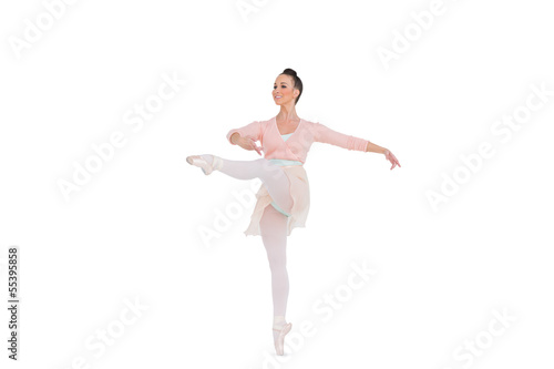 Smiling gorgeous ballerina spinning on one leg