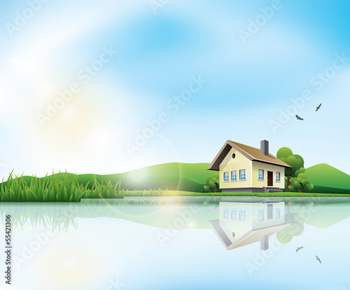 Beautiful sunny landscape with house and a lake