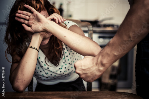 Woman covering her face in fear of domestic violence